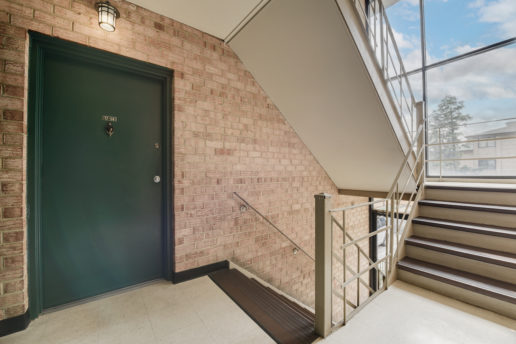 brigh stairwell and green door with natural light